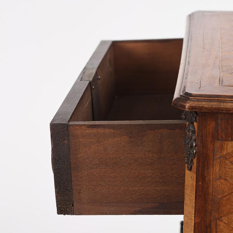 A Louis XVI-style parquetry commode, circa 1900.