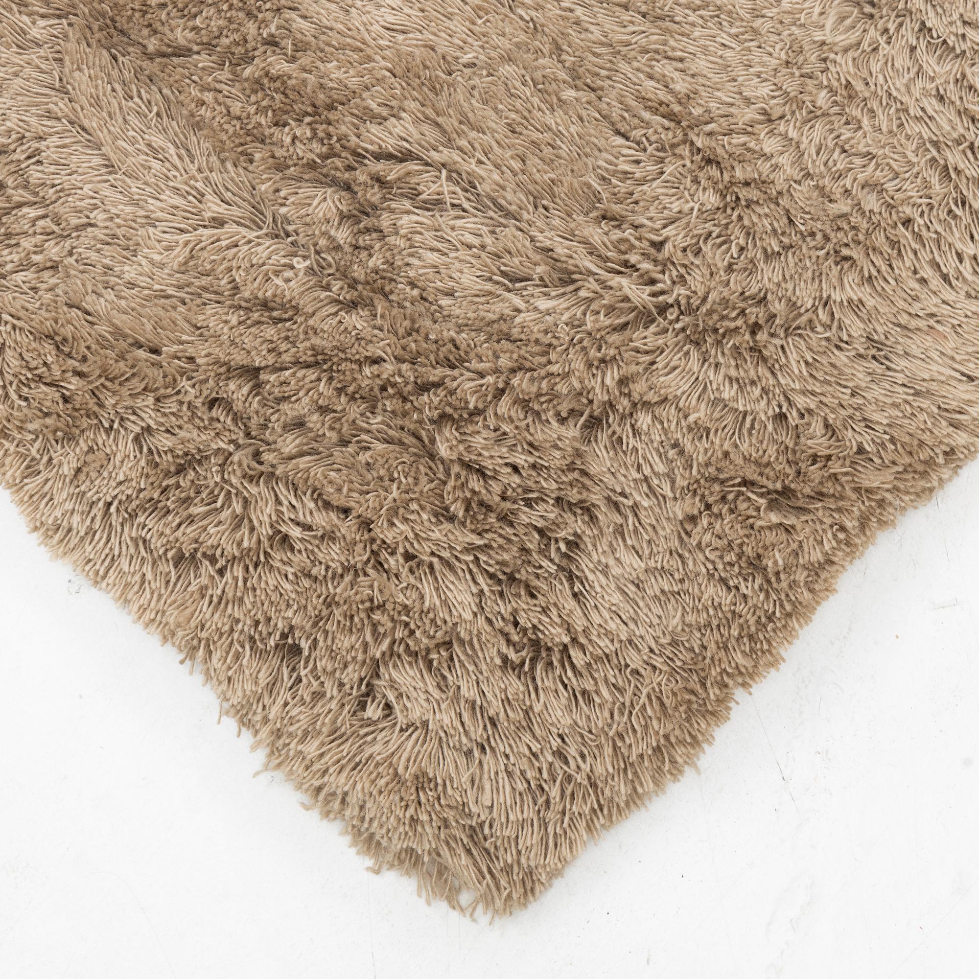 A monochrome carpet, 'Fallingwater - Mocha' by Layered, ca 400 x 300 cm.