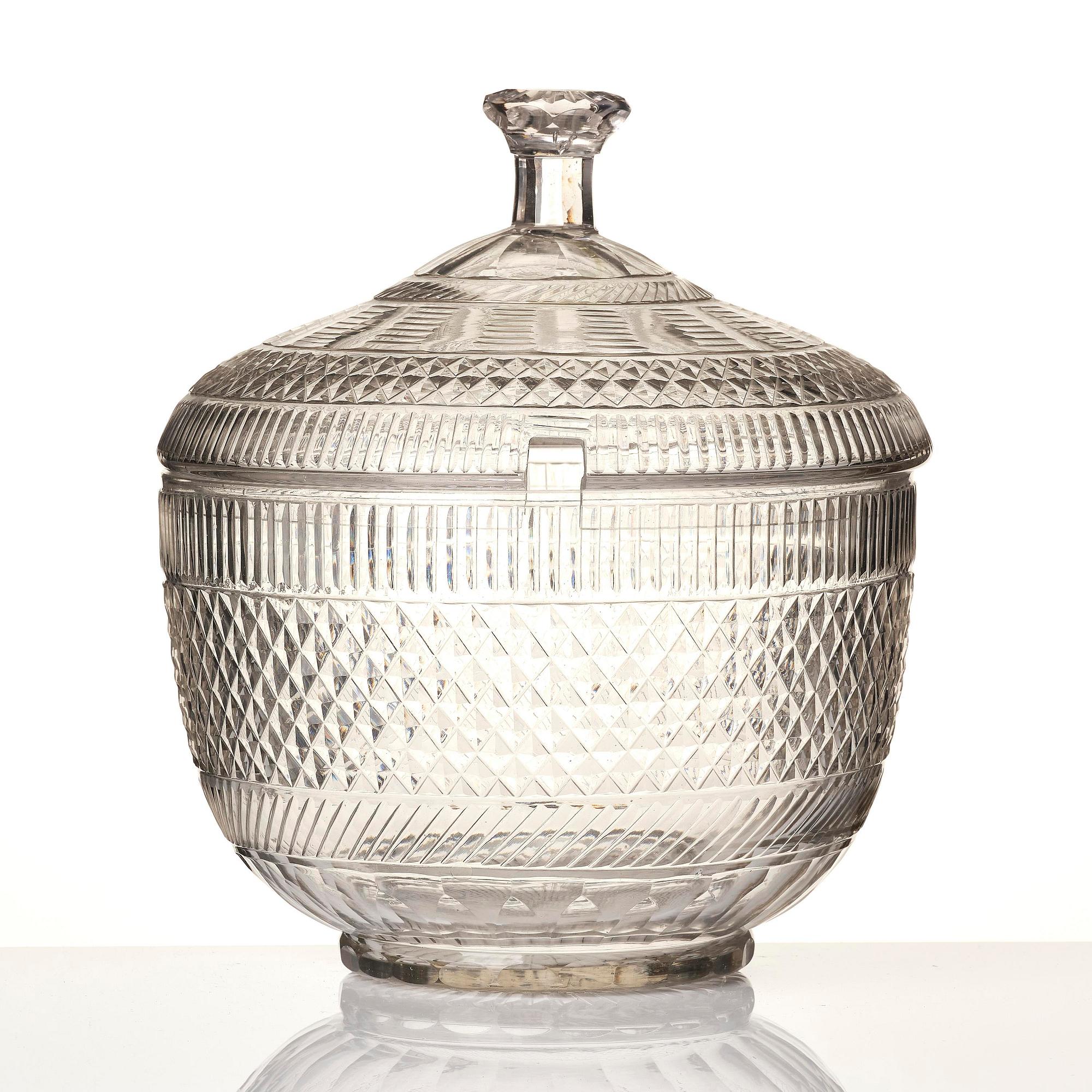 A cut glass punch bowl with cover, stand and ladle, Empire, first part of the 19th century.