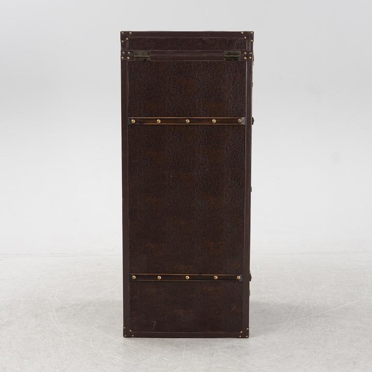 A leather suitcase-shaped bar cabinet.