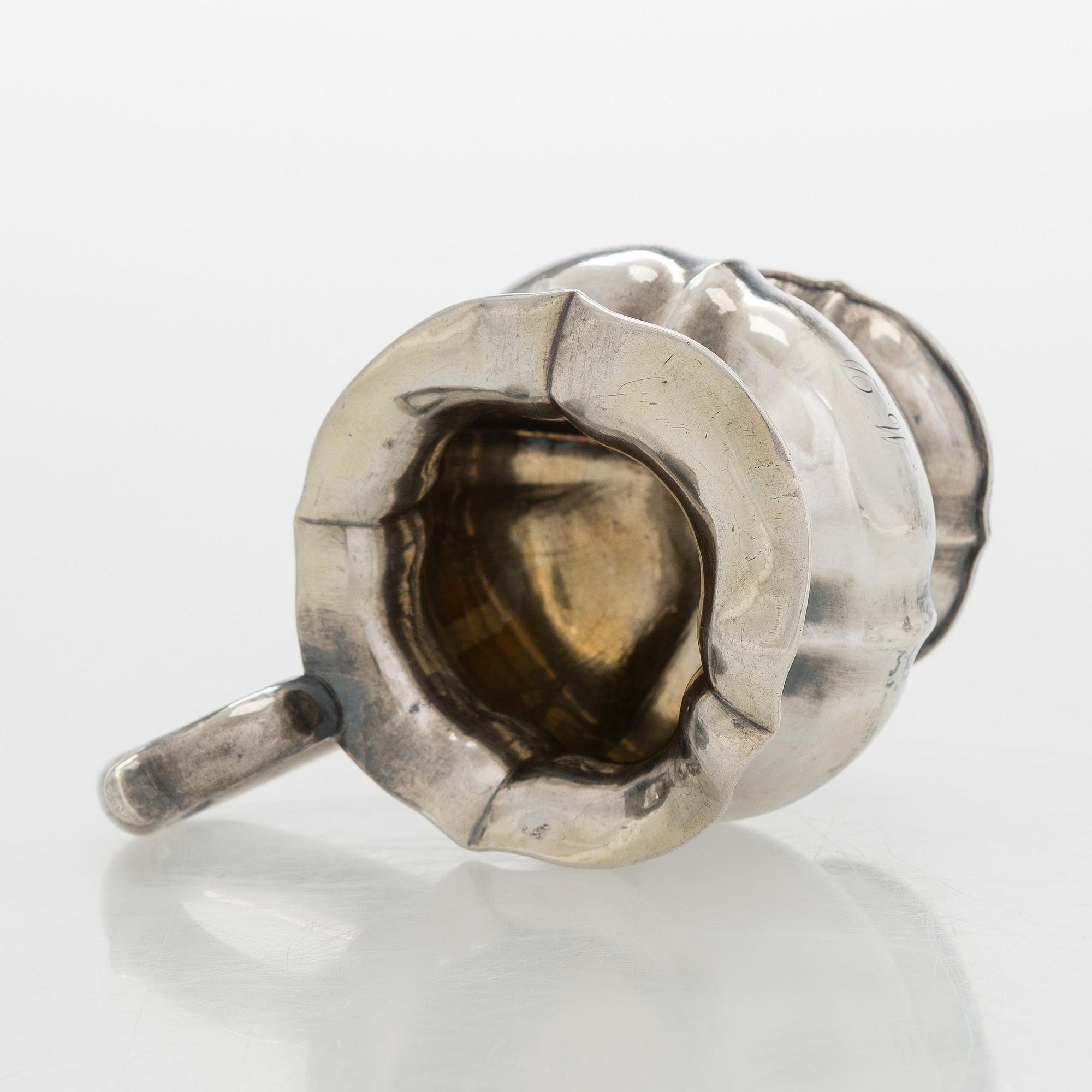 A silver cream jug, maker's mark of Michael Takkinen, St. Petersburg 1856.