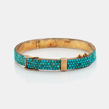 A silver and turquoise bracelet.