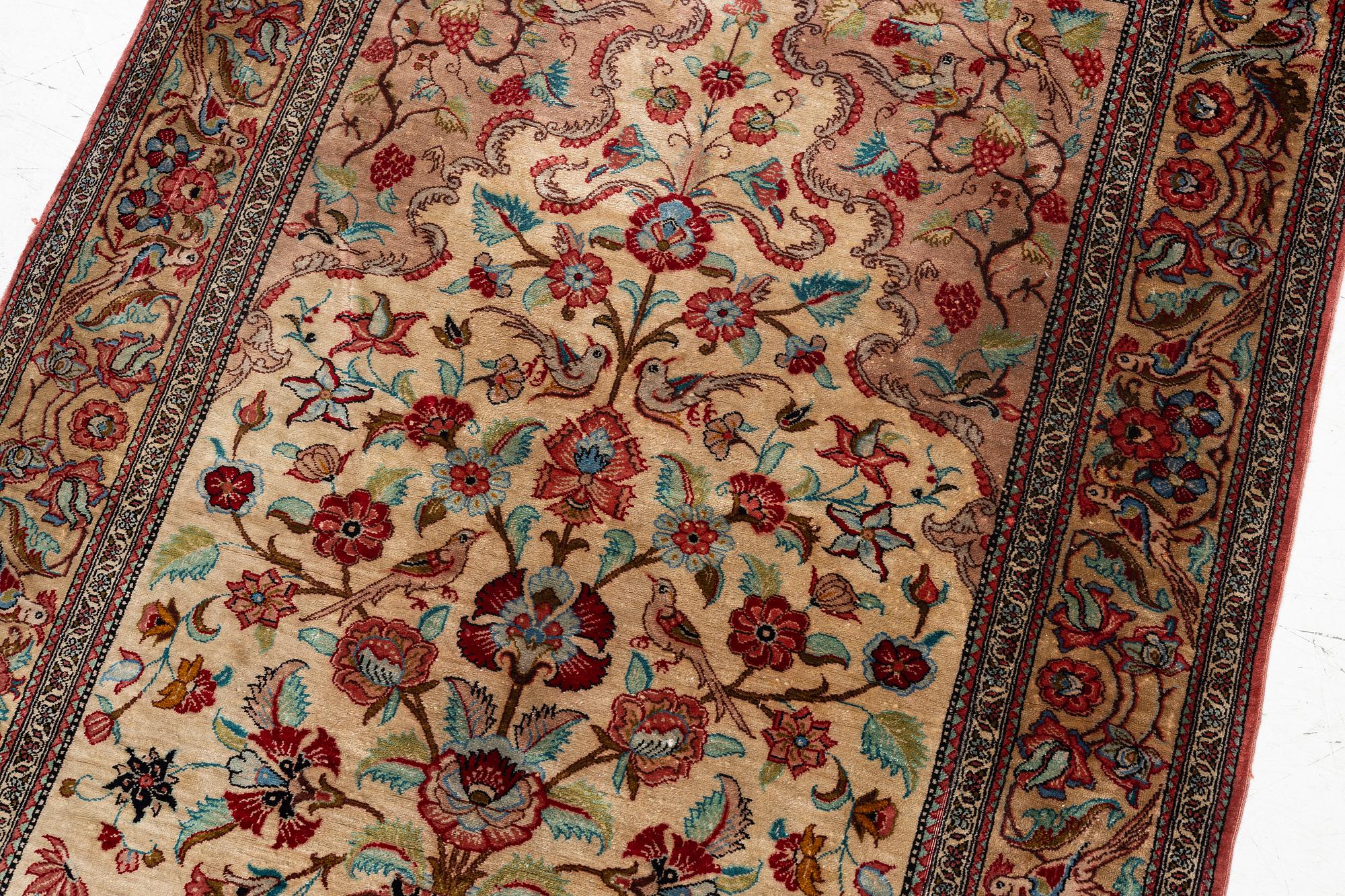 A Qum silk rug, c. 110 x 76 cm.