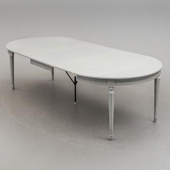 A Gustavian style dining table and ten chairs, 20th century.