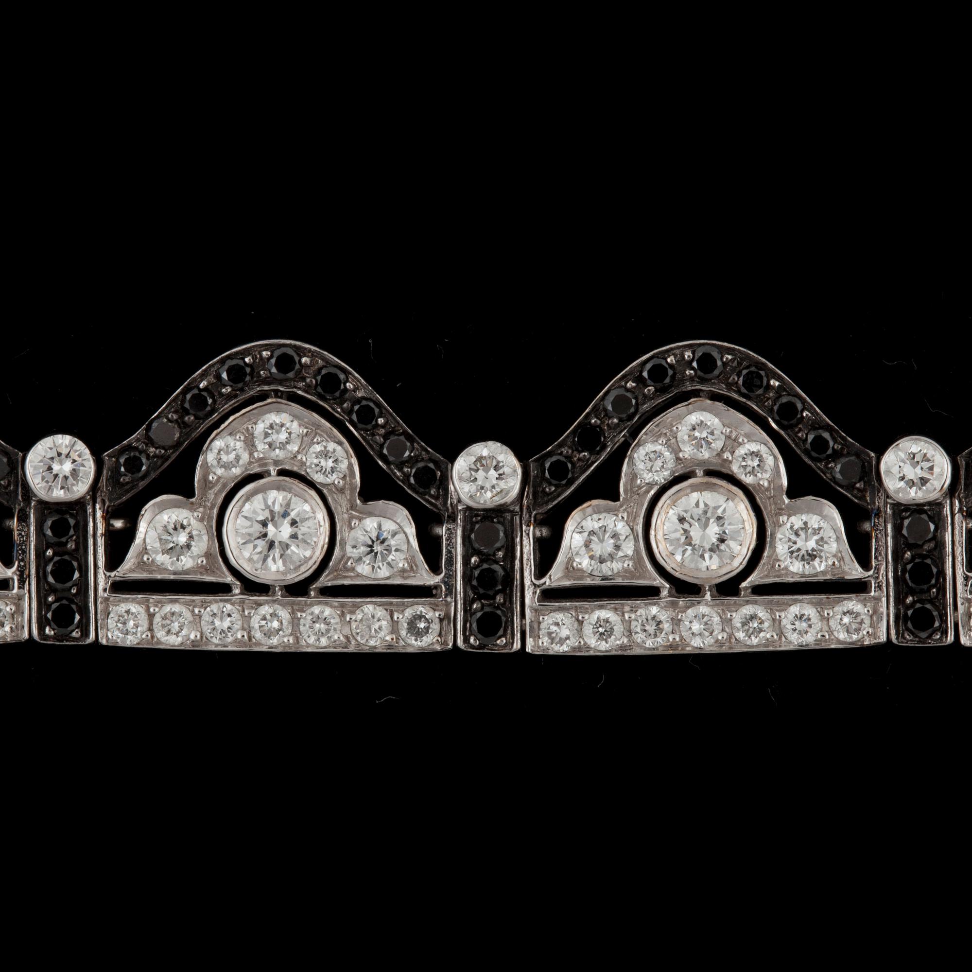A black and white diamond bracelet. Total carat weight 6.89 cts.