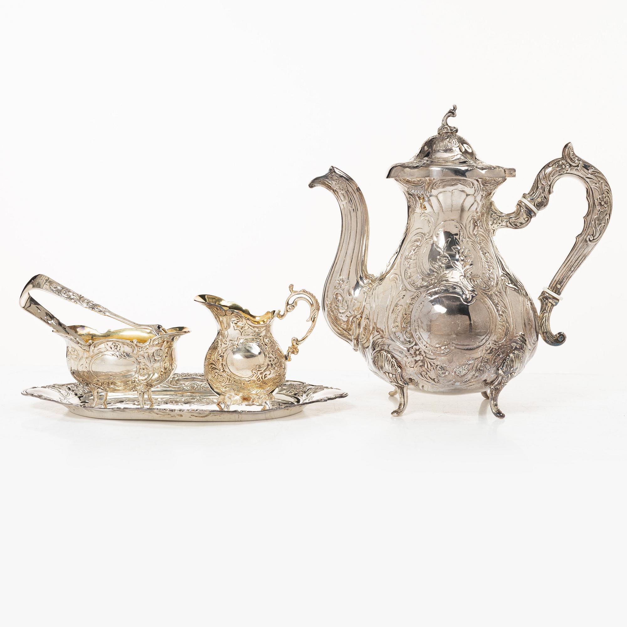 A Swedish silver Rococo style 4-piece coffee service, mark of Gewe, Malmö 1962-1978, and sugar tongs, Mylius, Norway.