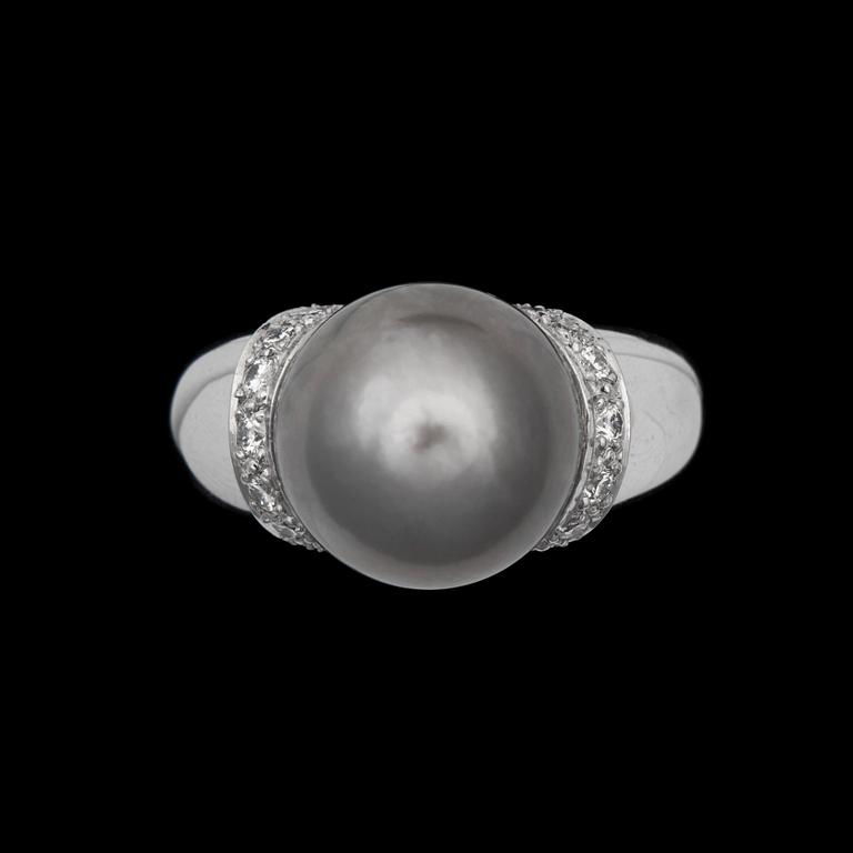 A cultured Tahiti pearl ring with brilliant cut diamonds.