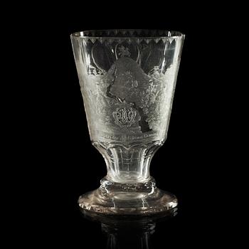 780. A cut and engraved glass beaker, dated 1740.
