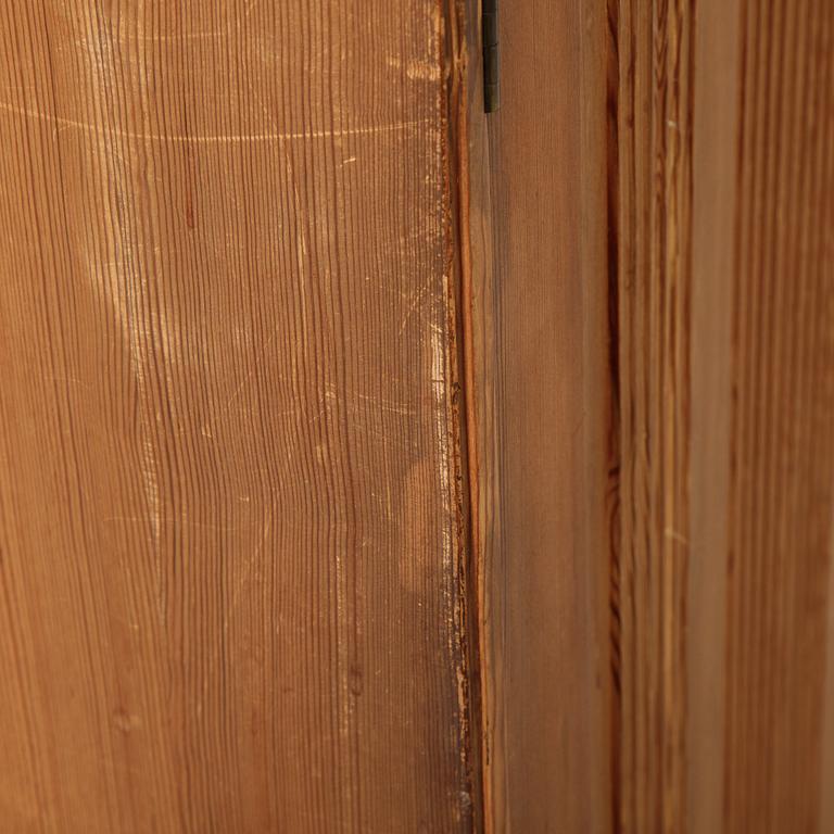 A pair of pine cupboards with shelves by Carl Malmsten.