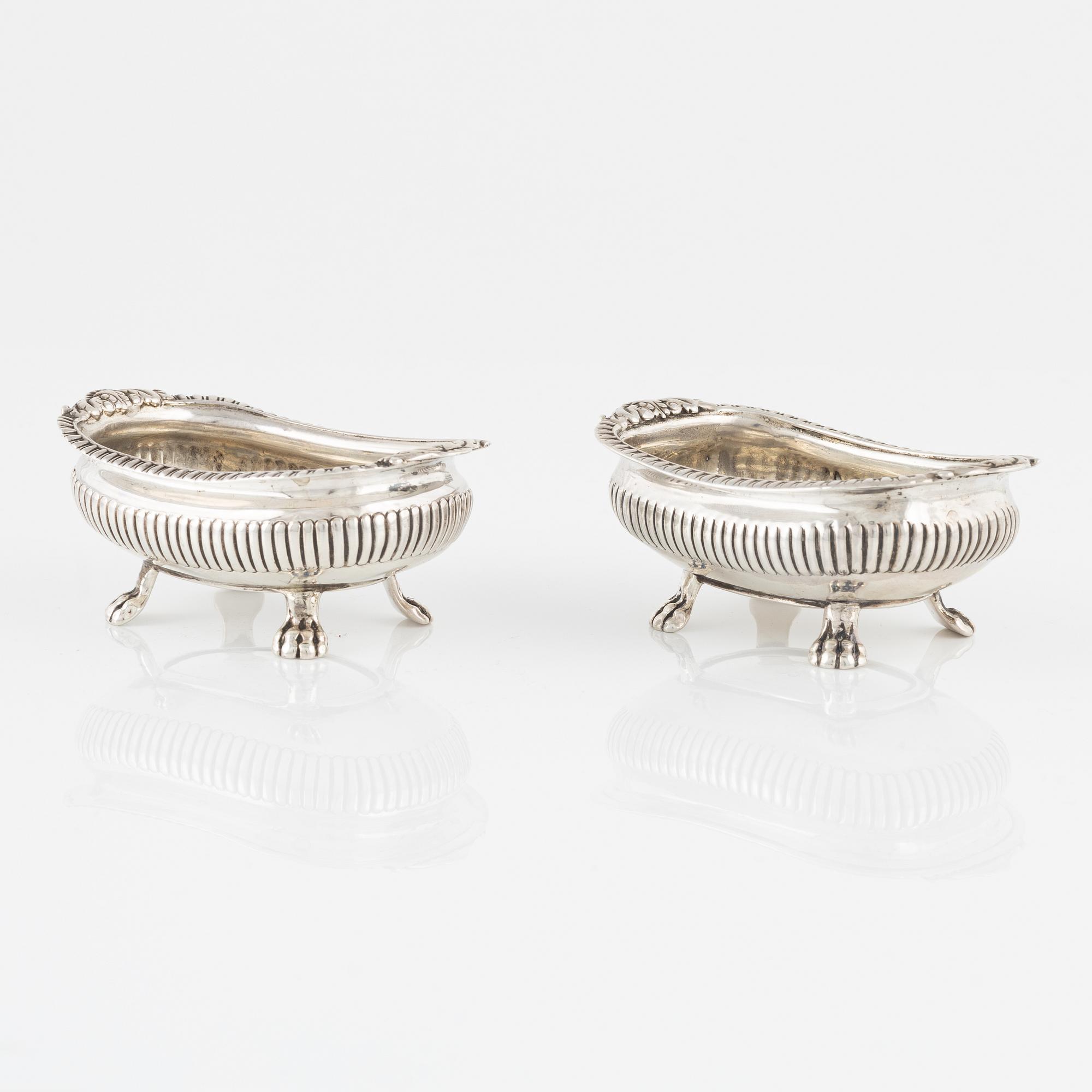 A pair of English Silver Salt Cellars, marks ofJoseph Angell Il 1823 and Samuel Dutton 1826 respectively, London.