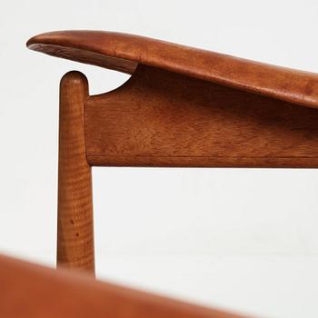 Finn Juhl, a teak and natural brown leather "Chieftain Chair" by Niels Vodder, 1950-60's.