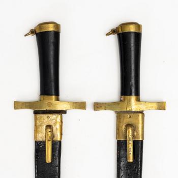Two Swedish cutlasses 1856 pattern, with scabbards.