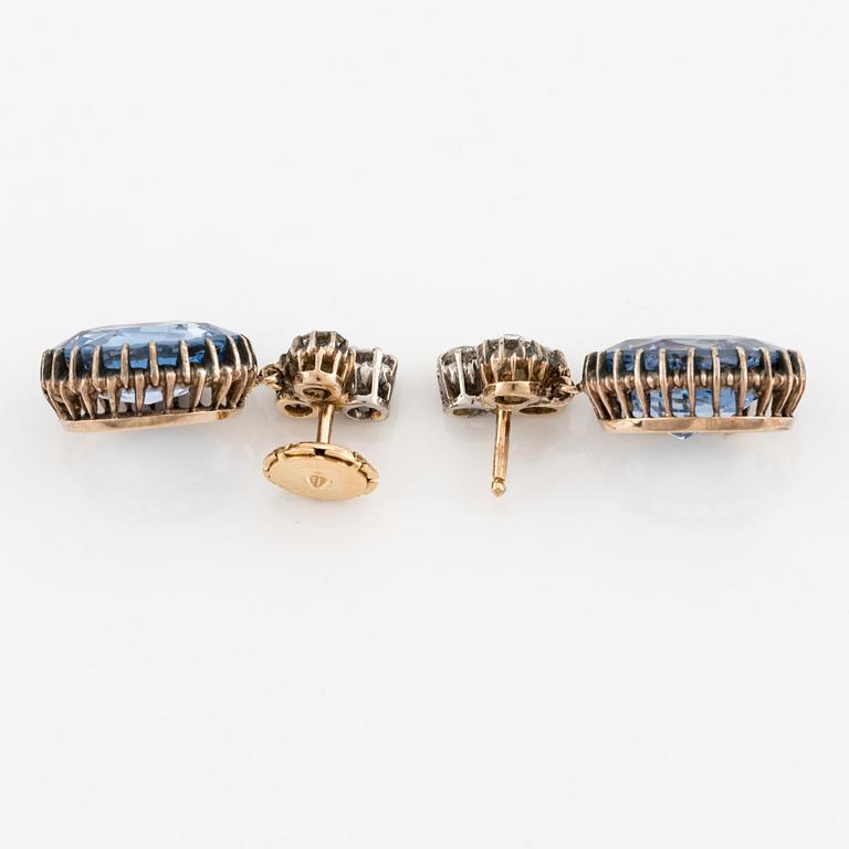 A pair of 14K gold earrings with faceted sapphires and old-cut diamonds.