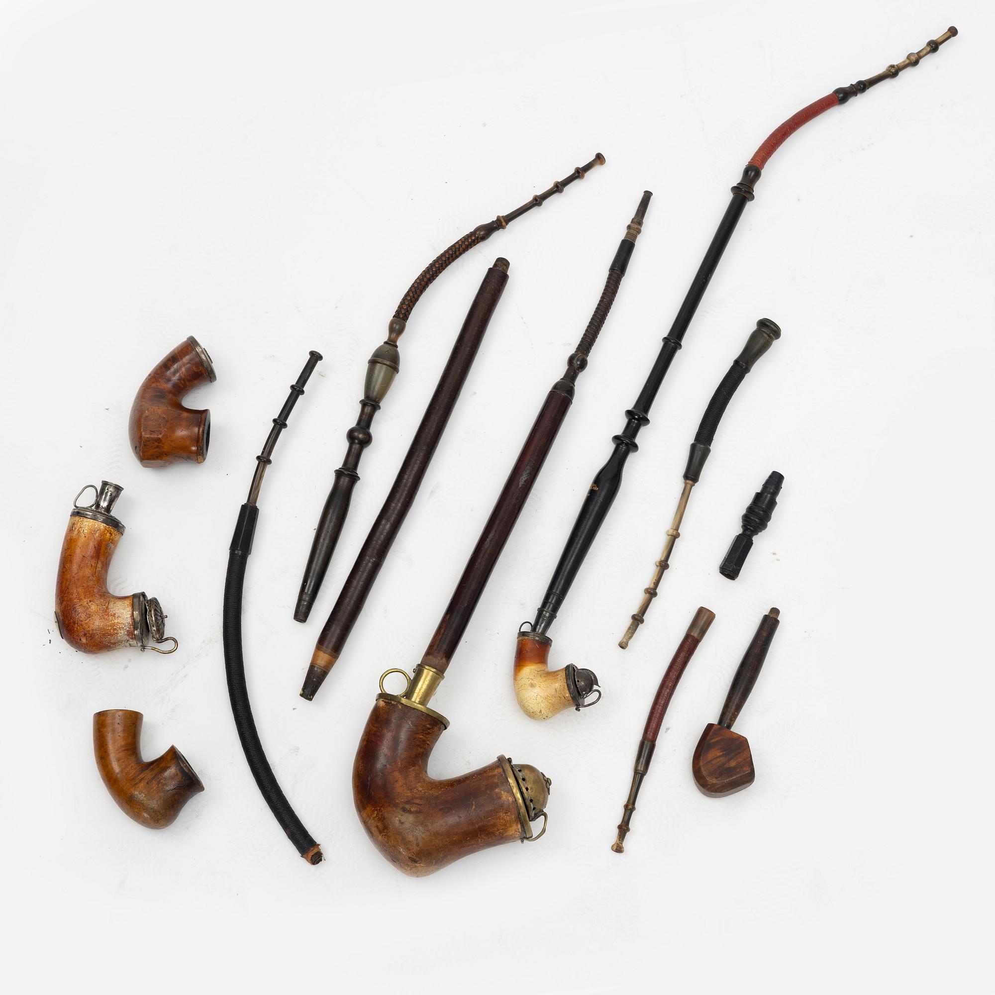 A pipestand and four pipes, circa 1900.