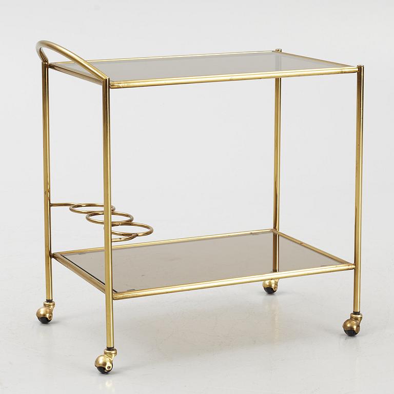 A 1970's glass and brass drinks trolley.