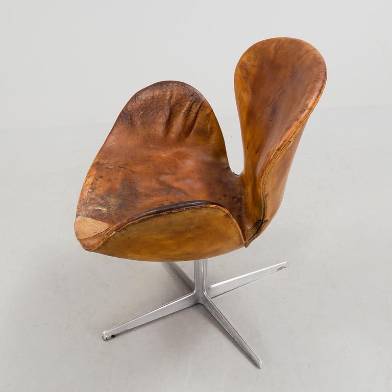 An Arne Jacobsen steel and brown leather 'Swan' chair, Fritz Hansen, Denmark 1960's.