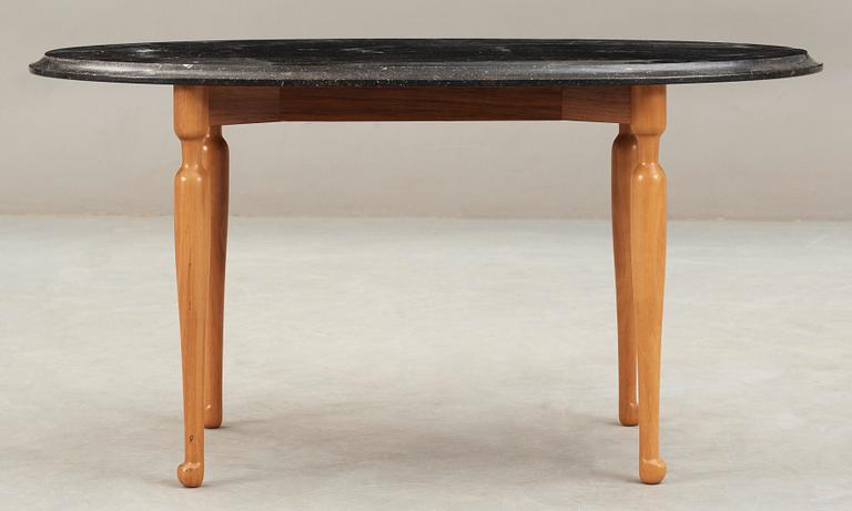 A Josef Frank black marble top table on a mahogany and walnut base, Svenskt Tenn, Sweden.