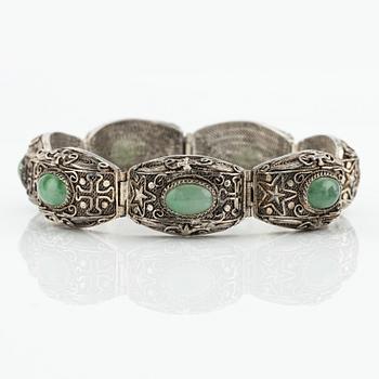 A Chinese silver and green stone bracelet and a pair of earrings, early 20th century.