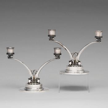 128. Harald Nielsen, a pair of sterling silver candelabra, Georg Jensen, Copenhagen 1933-44, model nr 278.