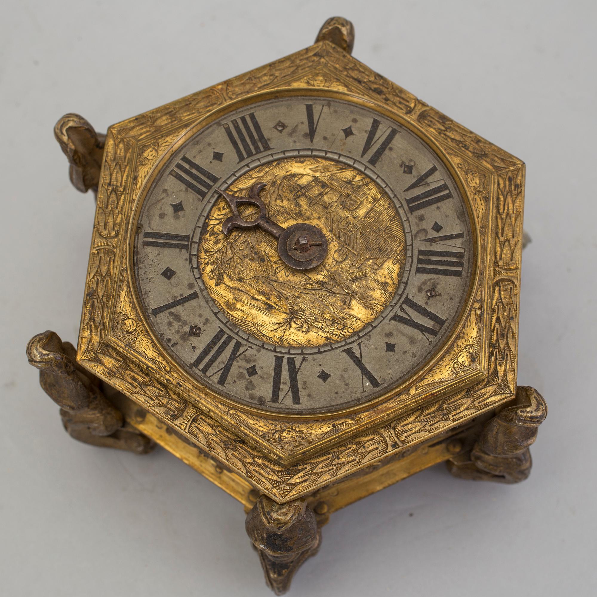 A gilded brass baroque travel clock from around 1700, with original case.