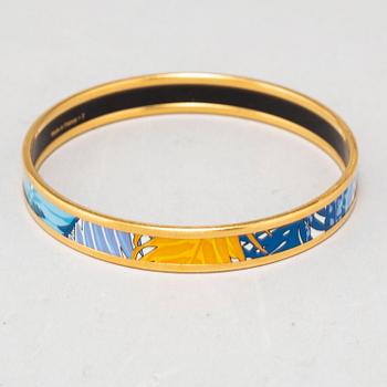 HERMÈS, a metal and enamel bangle.