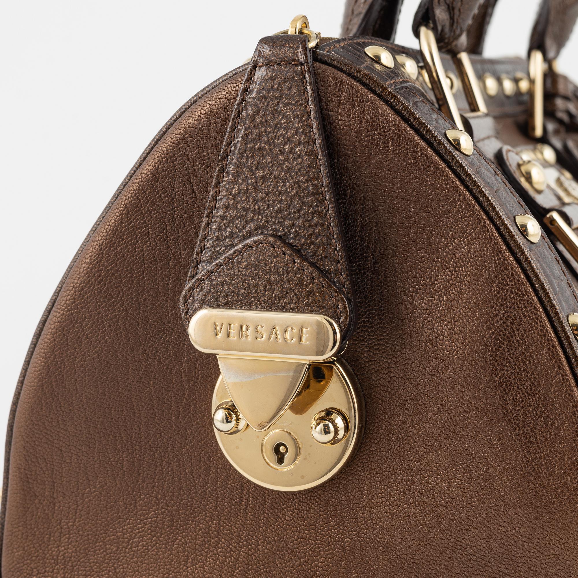 Versace, a bronze metallic leather handbag.