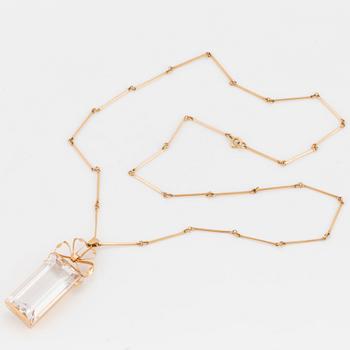 A chain and a pendant set with step-cut quartz.