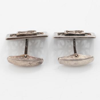 Four silver jewellery pieces: three brooches and a pair of cufflinks. With rose quartz and tiger’s eye. Finnish designers.