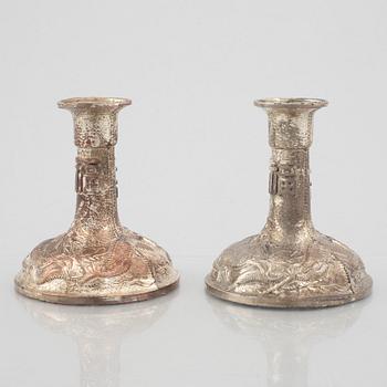 A pair of Chinese silver plated copper candle sticks, 20th century.