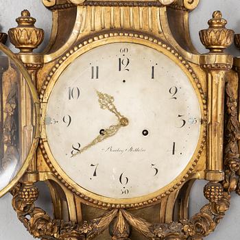 A Gustavian giltwood and parcel-gitl cartel clock by Per Henrik Beurling (Stockholm 1783-1806).
