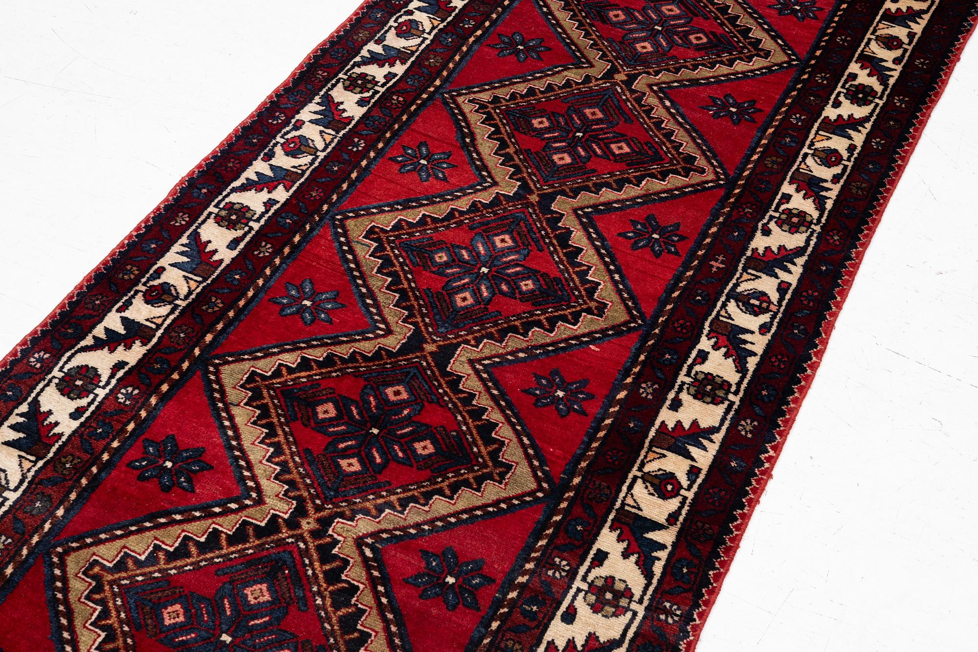 An oriental runner, c. 395 x 100 cm.