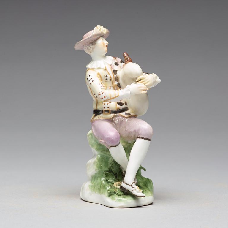 A porcelain figure of a bagpiper, 'Meissen mark'.