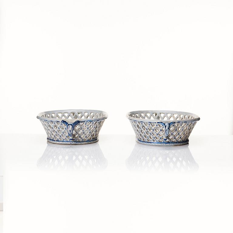 A pair of Swedish Rörstrand faience chesnut baskets, both dated 23/1 1759.