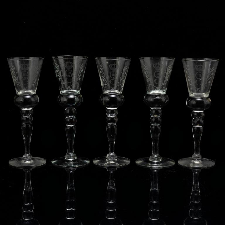 A set of five snapps glasses and a snapps bottle, with Gustav III crowned monogram. 20th century, Baroque-style.