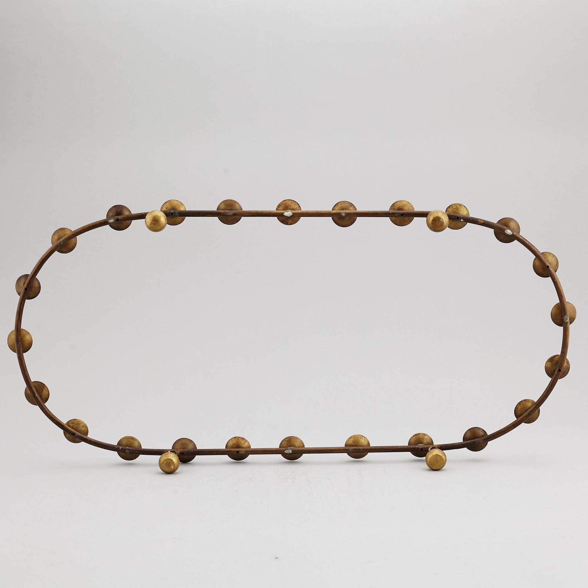 A mid 20th Century brass candle ring.