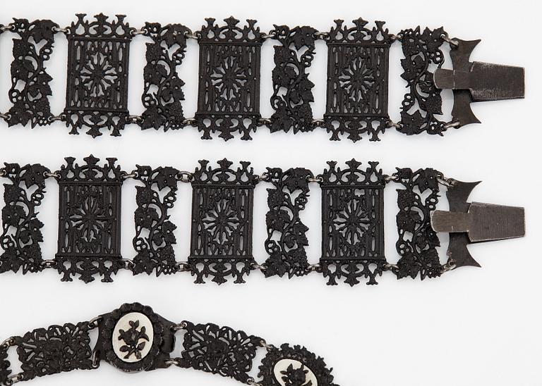 A Berlin steel and iron parure comprising a necklace, two bracelets and a brooch.