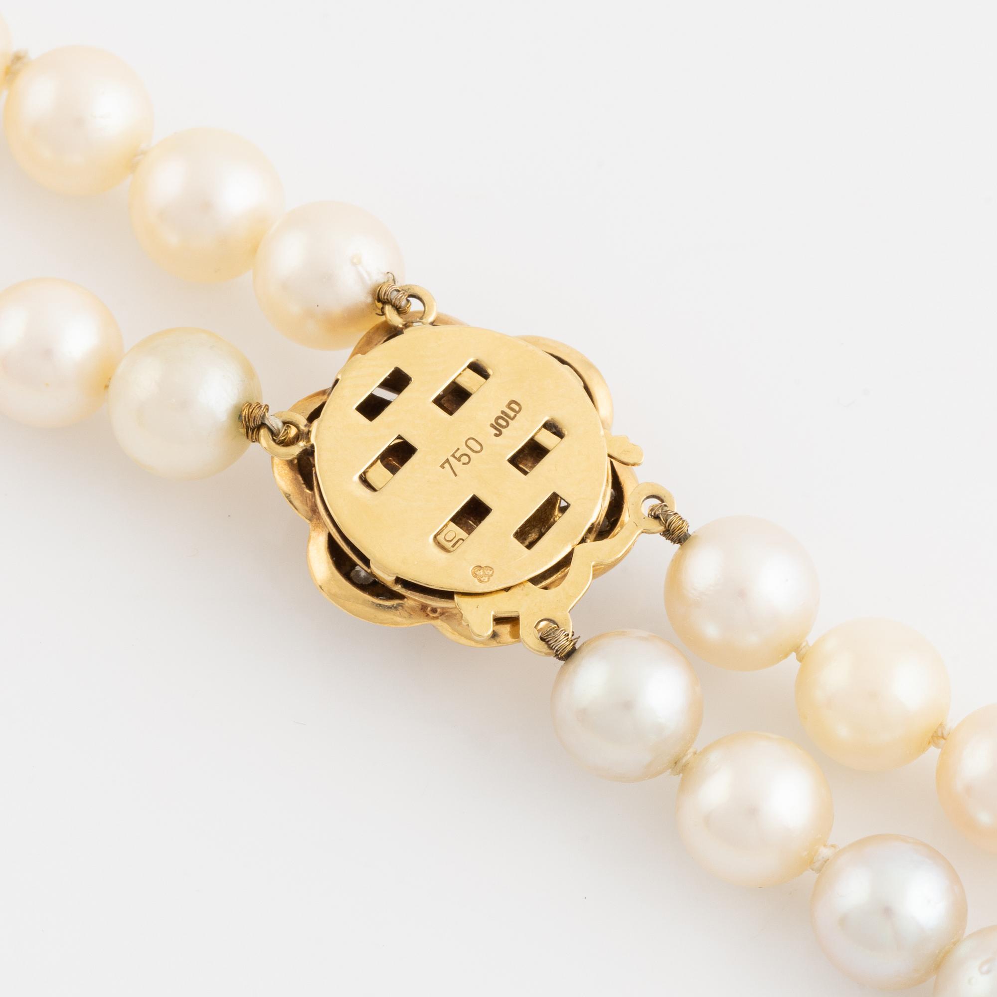 Two strand cultured pearl necklace, clasp 18K gold with half pearl and eight cut diamonds.
