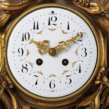A French  Louis XVI-style wall clock, around 1900.