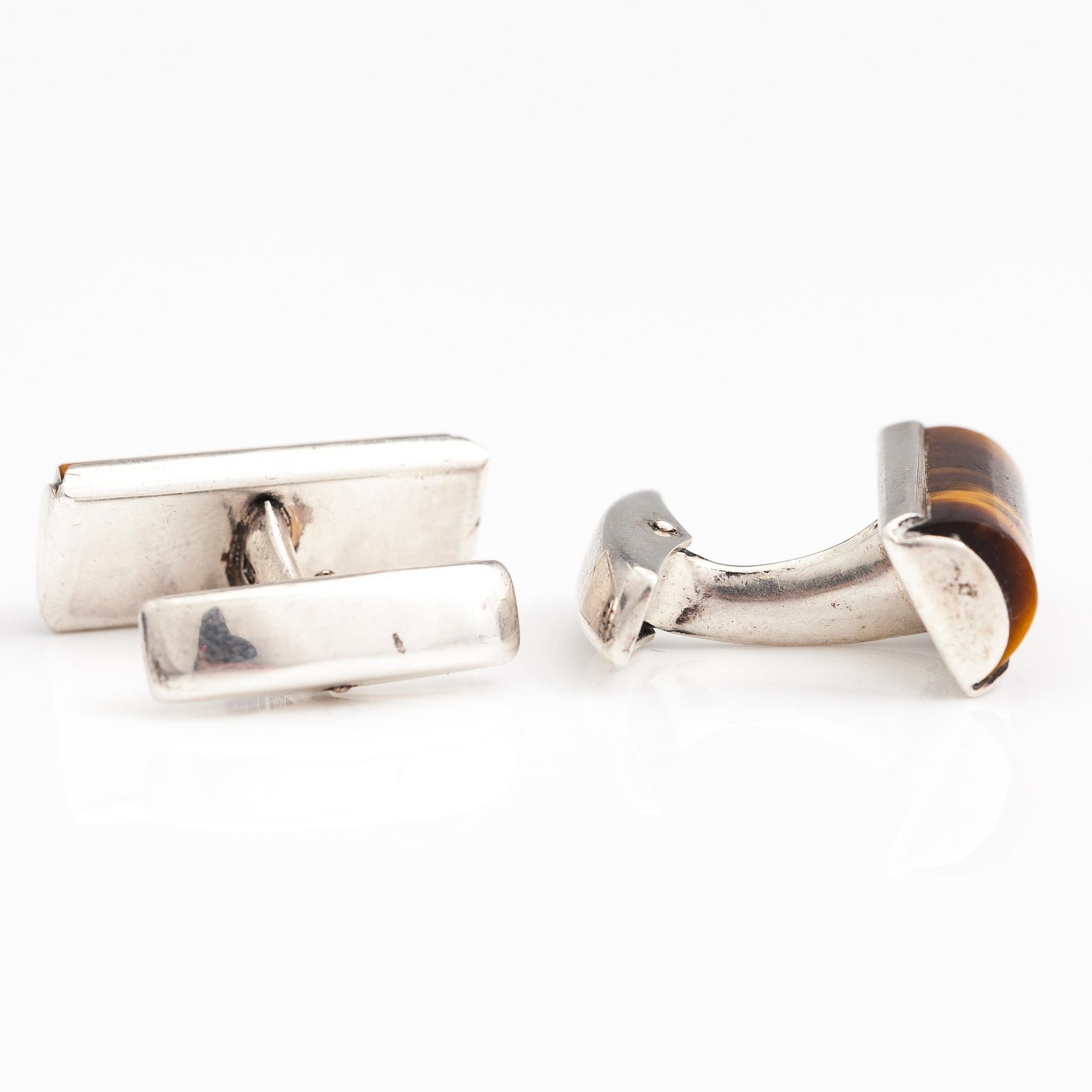 A set of three pairs of silver cufflinks with hematite, tigers eye and granite. Turun Hopea and Osvald Mättö.