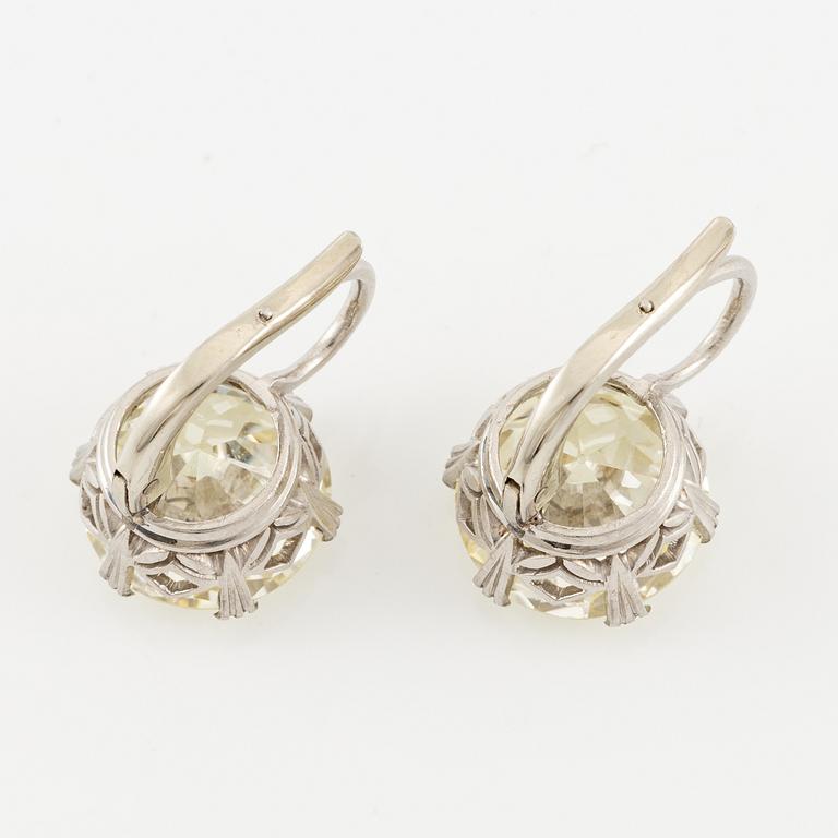 A pair of earrings in 18K white gold set with two old-cut diamonds.