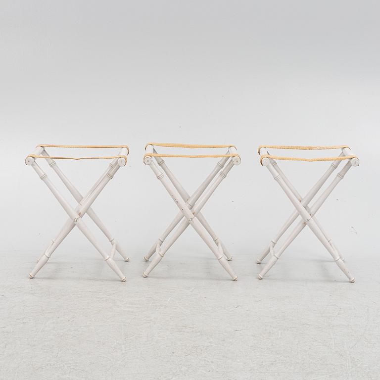 A set of three luggage stands, 20th century.