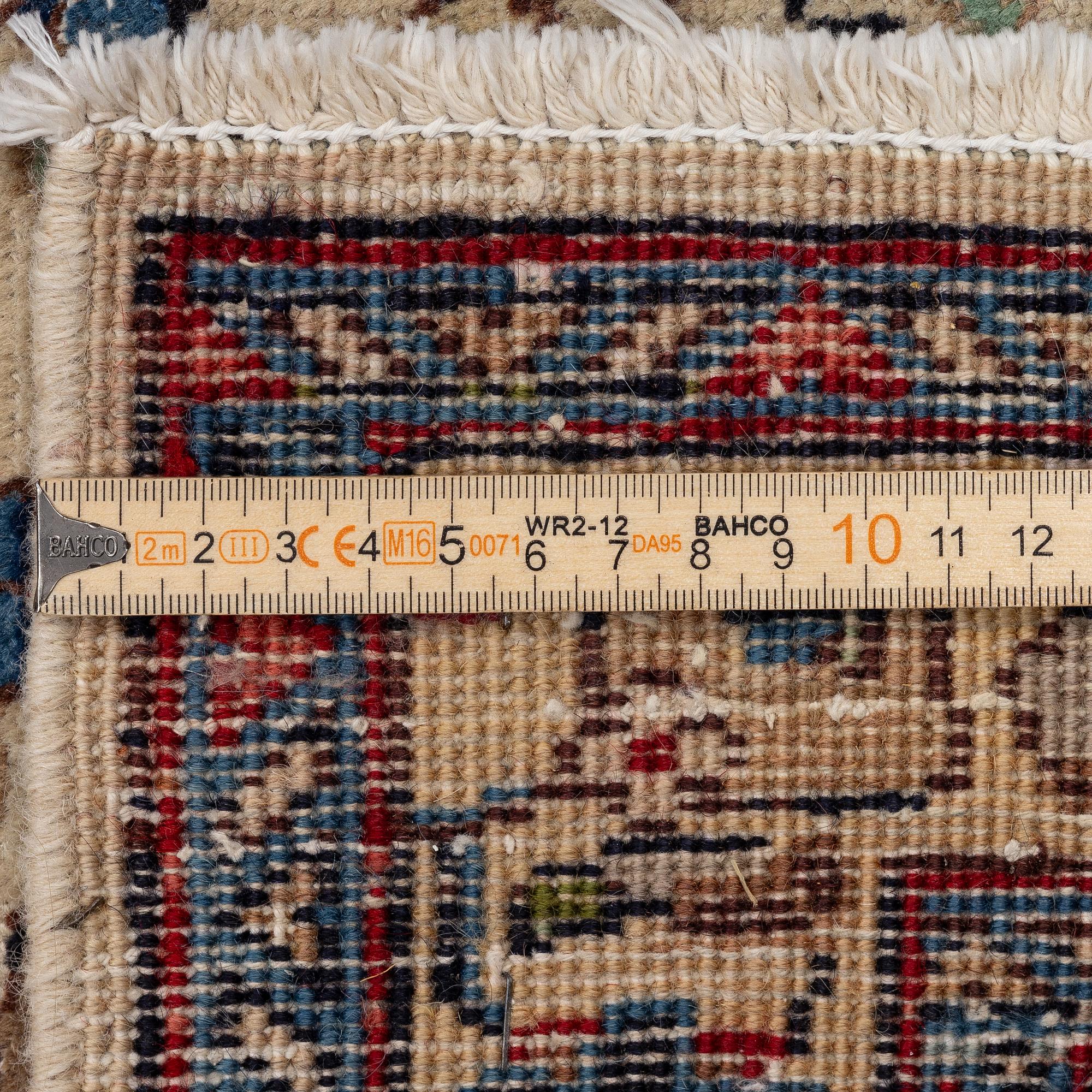 A Tabriz carpet, c. 385 x 287 cm.