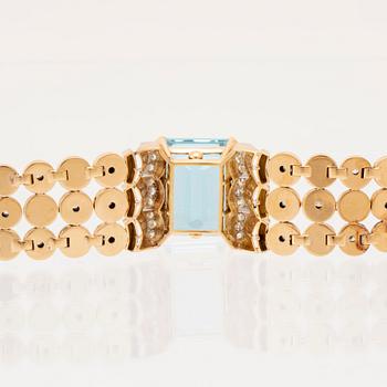 An 18K white and red gold bracelet set with rectangular step-cut aquamarine and round old-cut and brilliant-cut diamonds.