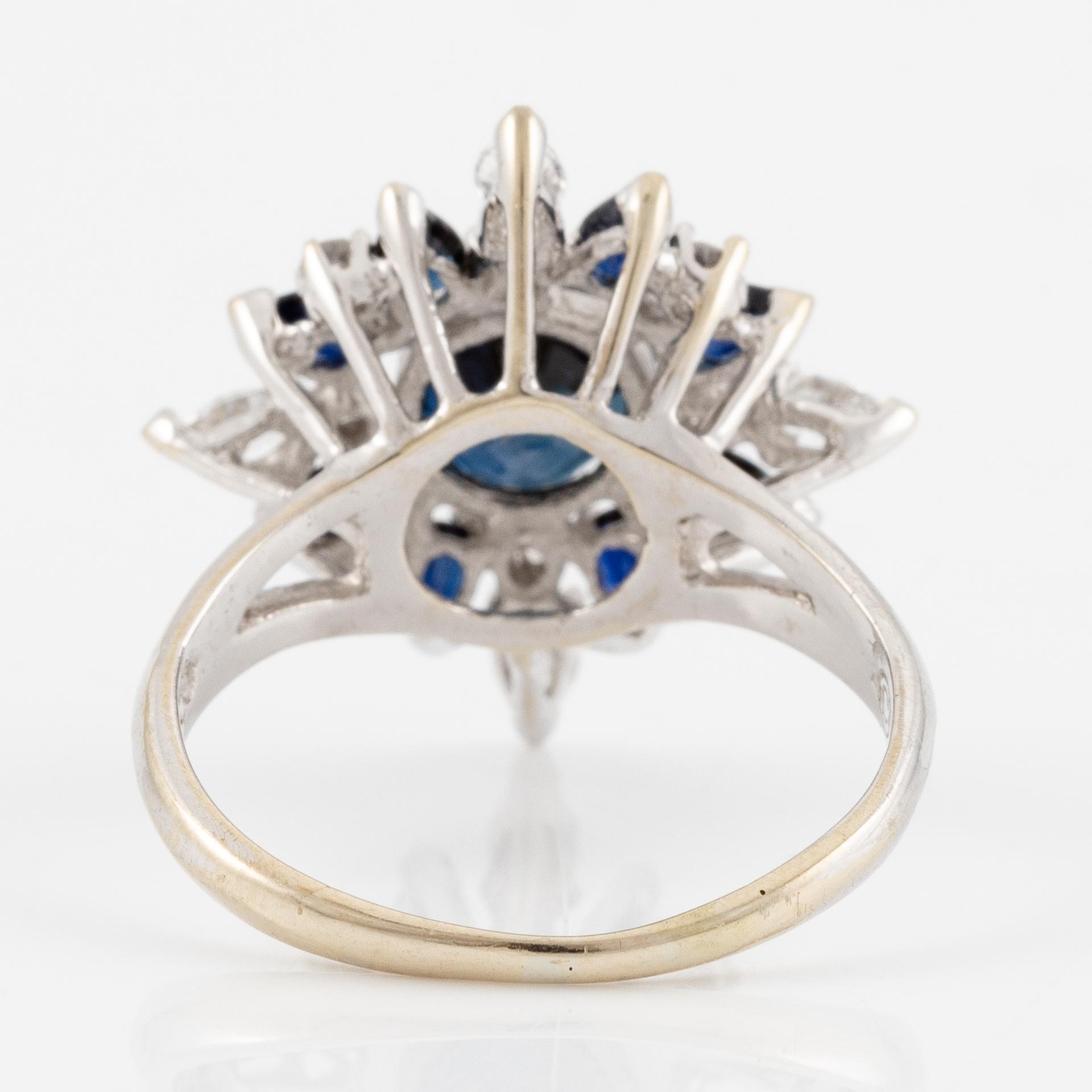 Ring 18K white gold with dark sapphires, pear-shaped and brilliant-cut diamonds.