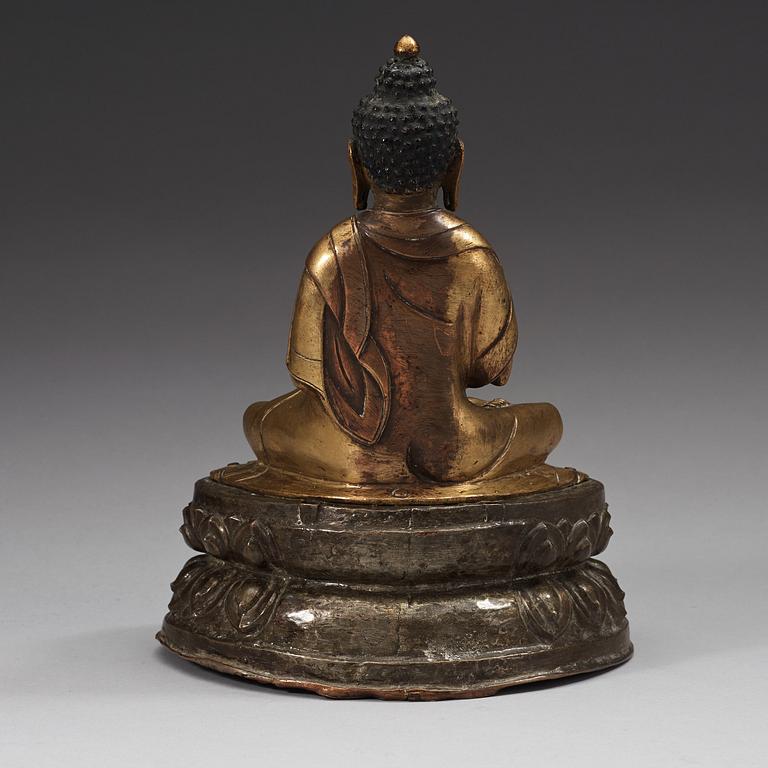 A gilt and silvered copper alloy repoussé figure of Sakyamuni Buddha, Tibet/Nepal, 18th Century.