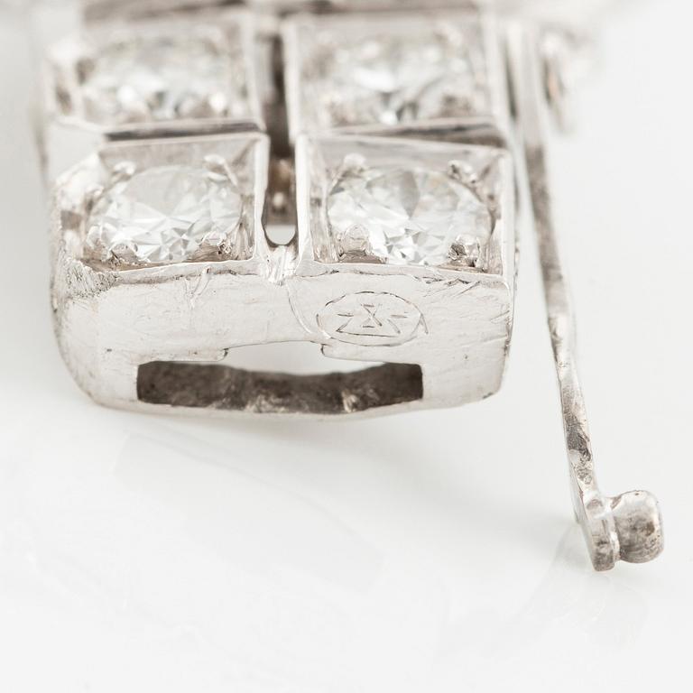 A platinum bracelet with round brilliant-, eight- and baguette-cut diamonds, Gübelin, founded in 1854.