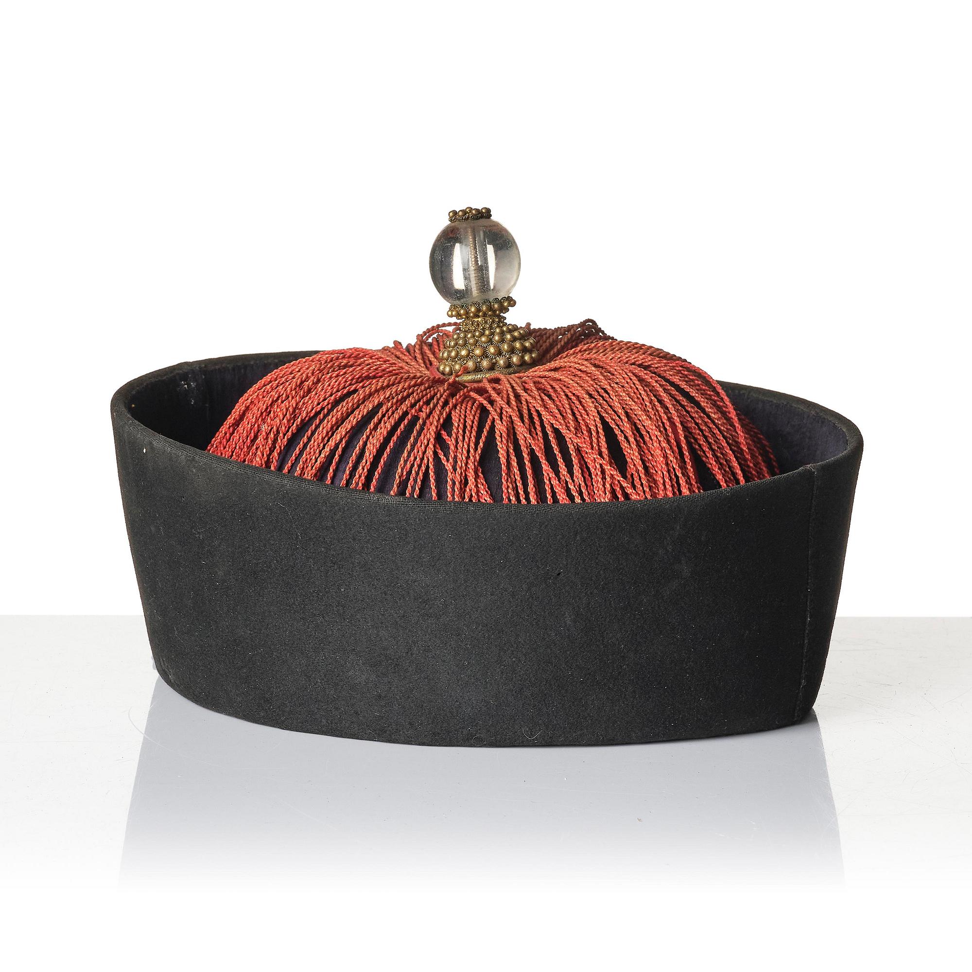 Two boxes with a mandarin's summer hat and black satin autumn hat and feather with six mandarin hat insignias.