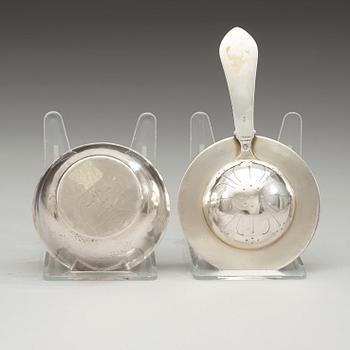 A Georg Jensen sterling tea strainer with its bowl, Copenhagen 1920's and 1933-44.