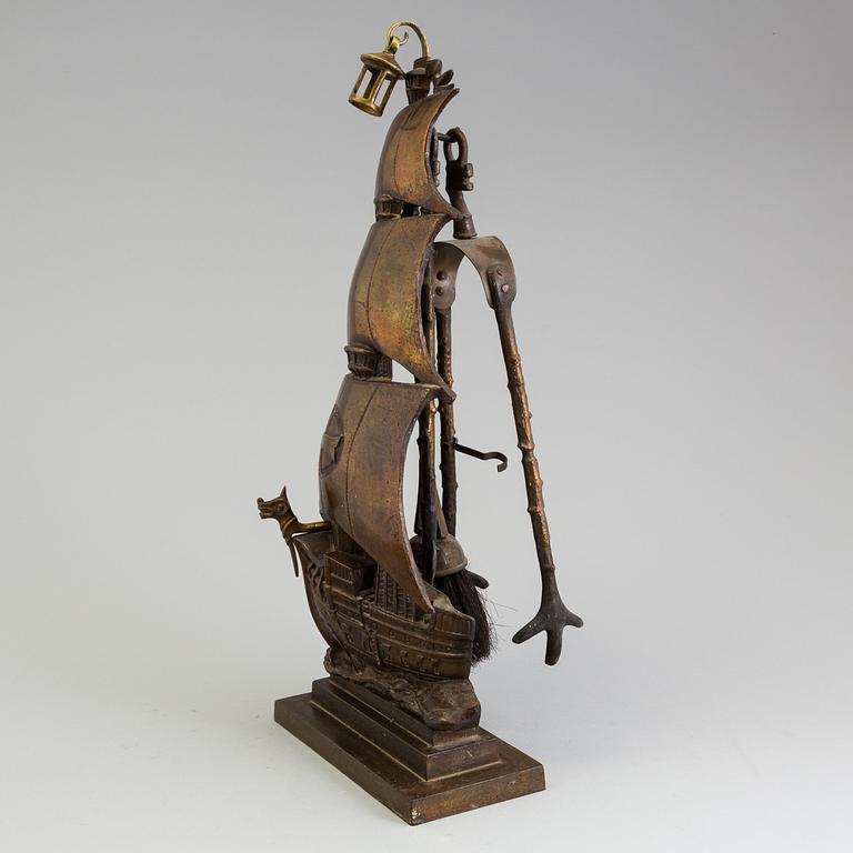 A set of three, early 20th century, bronze fire irons together with a stand, Nestor, England.