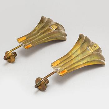 Four brass wall sconces  and one brass plate by Lars Homström, Arvika, second half of the 20th century.